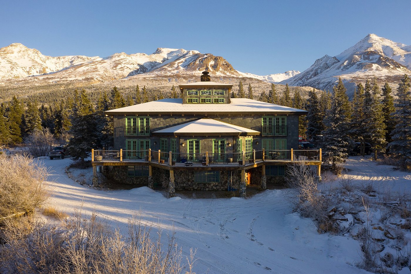 Black Rapid lodge in Alaska, featuring a functioning ski resort and a bustling winter sports centre. The stunning winter scenery and active winter sports scene add to the allure and adventure of the location.