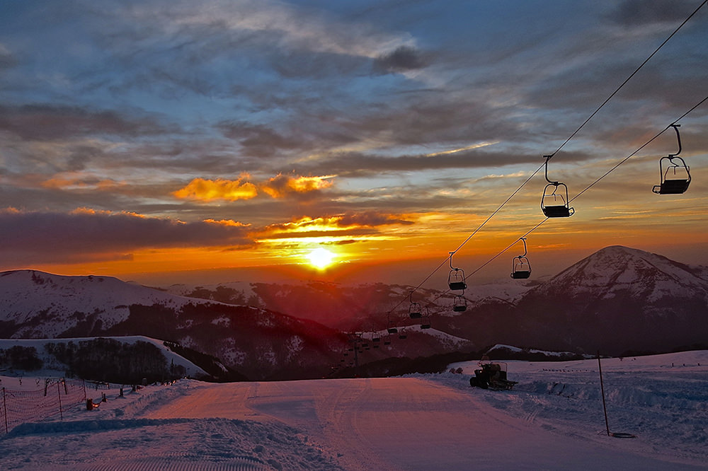 Monte Prata Ski in Italy - the sun is setting in the sky.