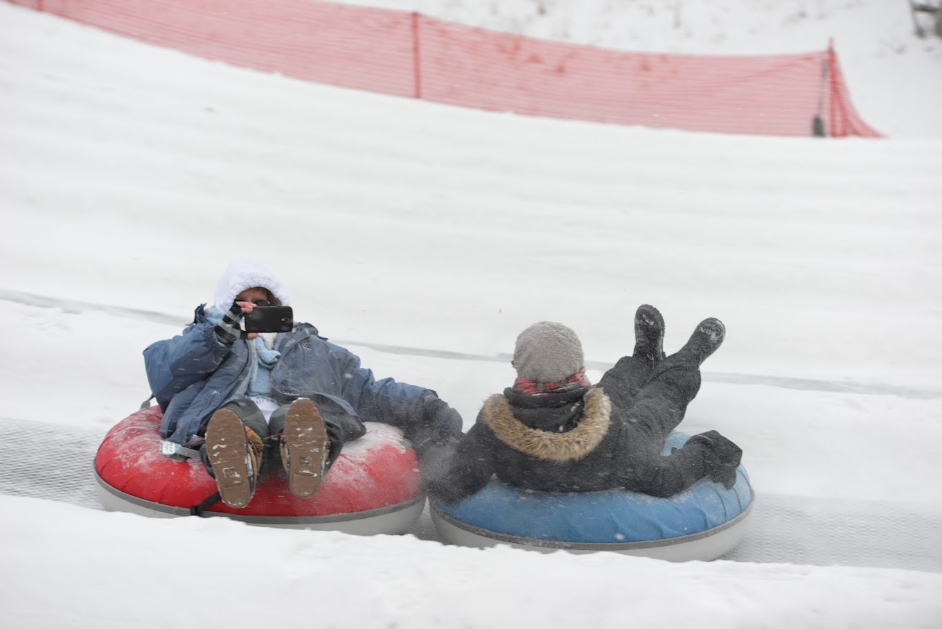 Hidden Valley - MO in USA - two people sledding down a hill.