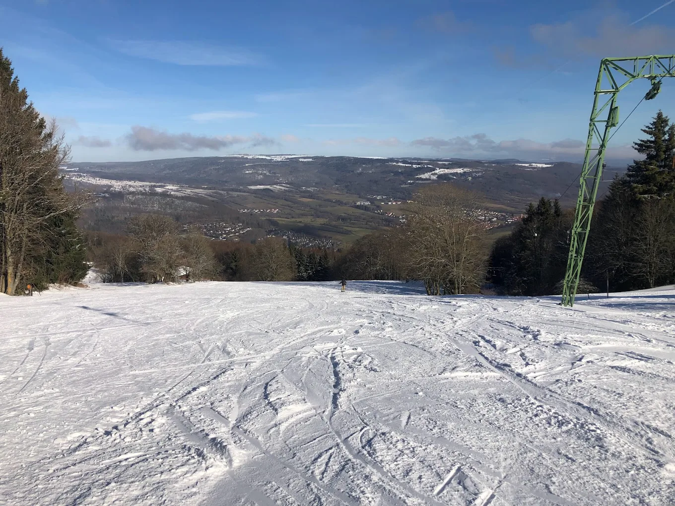 Skilifte Kreuzberg in Germany - a ski lift going down a snowy slope.