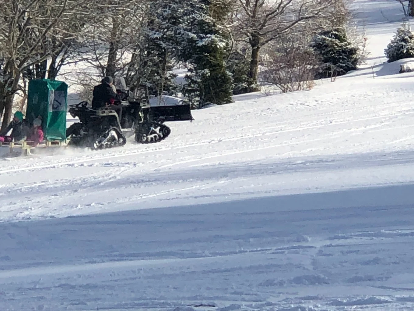 Skilifte Kreuzberg in Germany - a group of people skiing down a snowy hill.