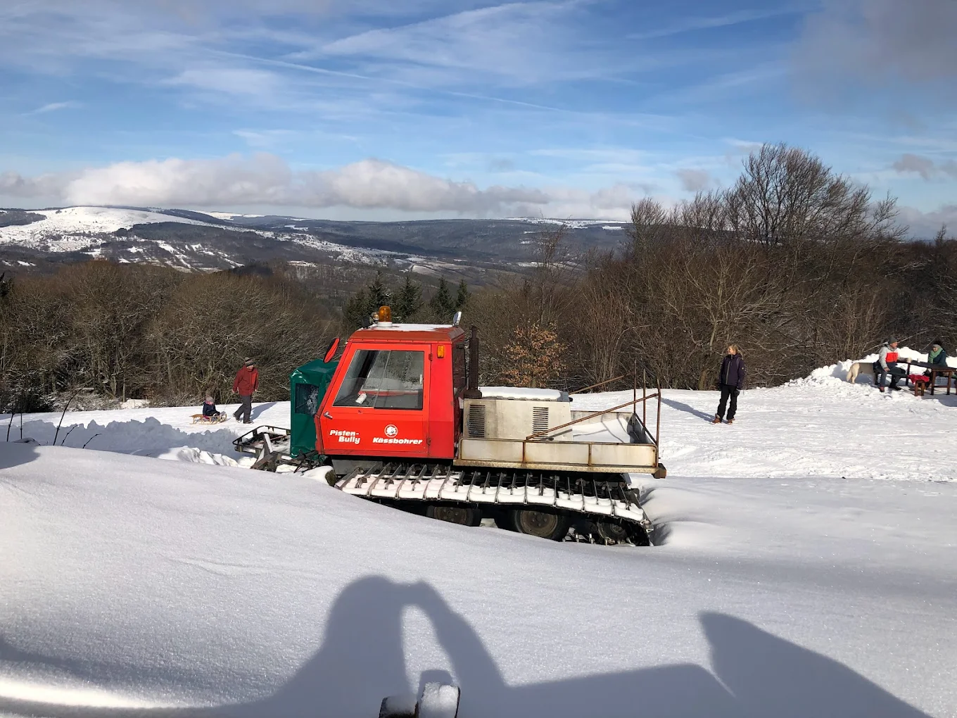 Skilifte Kreuzberg in Germany - a snow pling machine is parked in the snow.