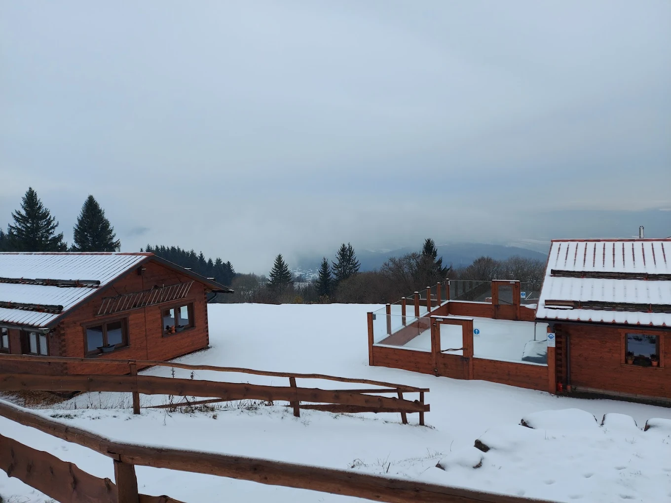 Skilifte Kreuzberg in Germany - a snow covered field with wooden cabins in the background.