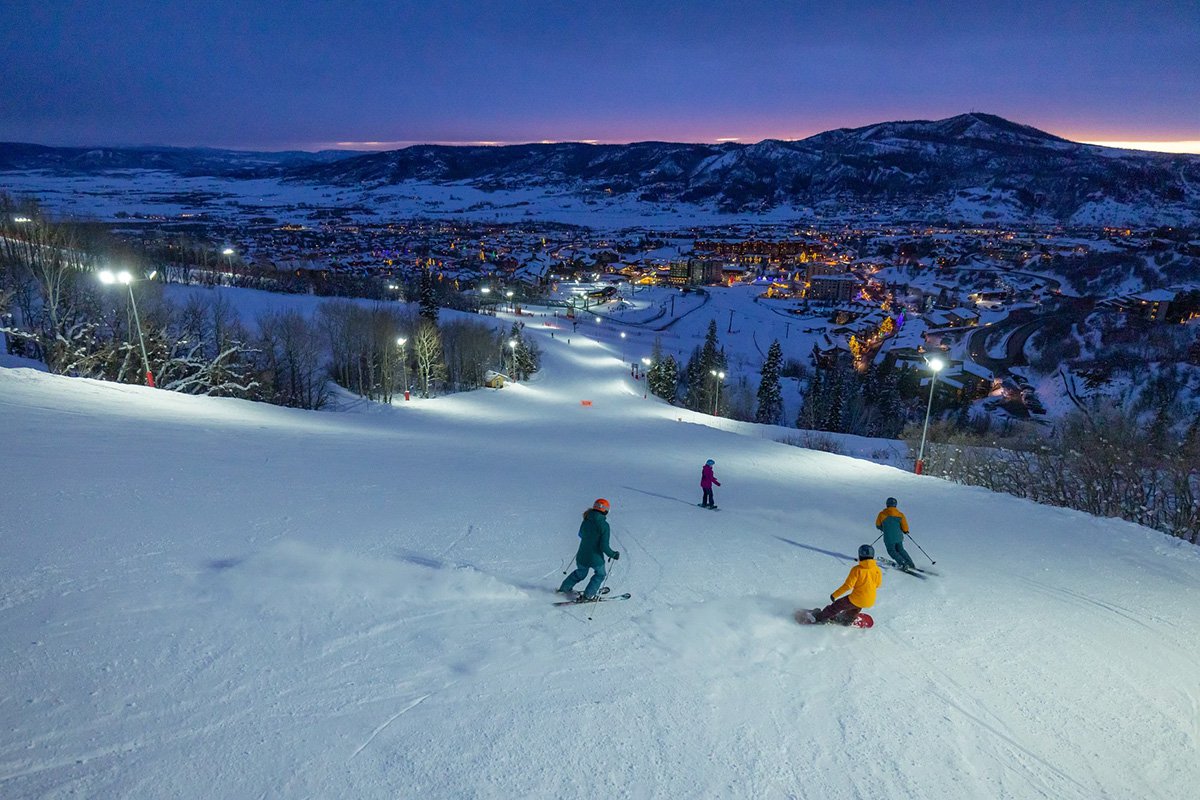 Steamboat in USA - two people skiing down a hill at night.