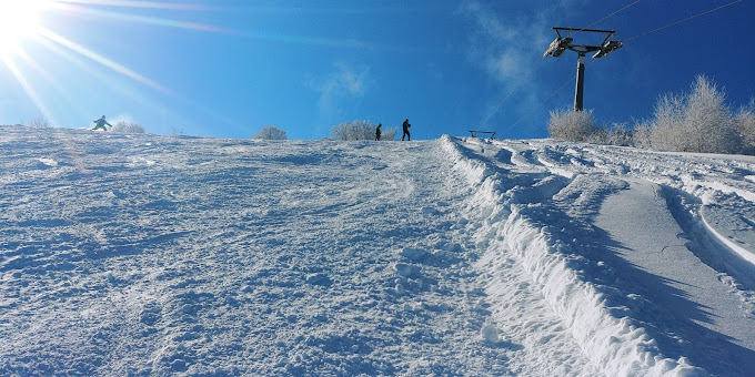 Gače in Slovenia - a person riding a ski board down a snow covered slope.