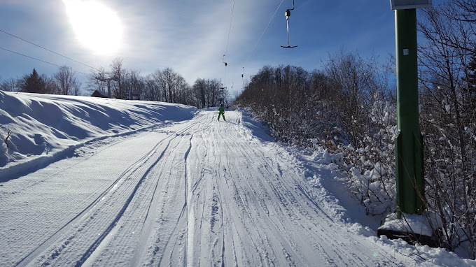 Gače in Slovenia - a person is skiing down a snowy hill.
