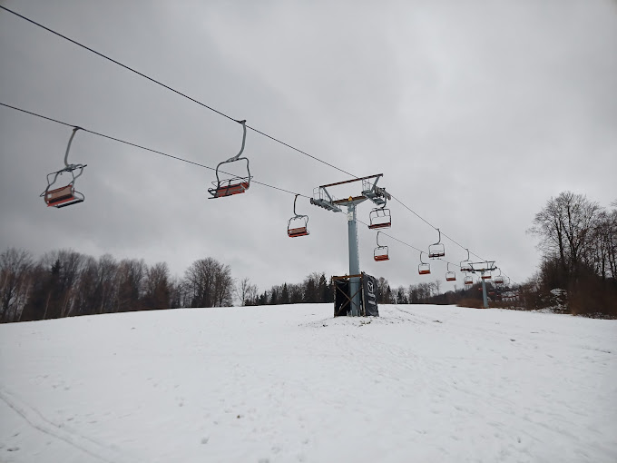 Gače in Slovenia - a ski lift going up a snowy hill.