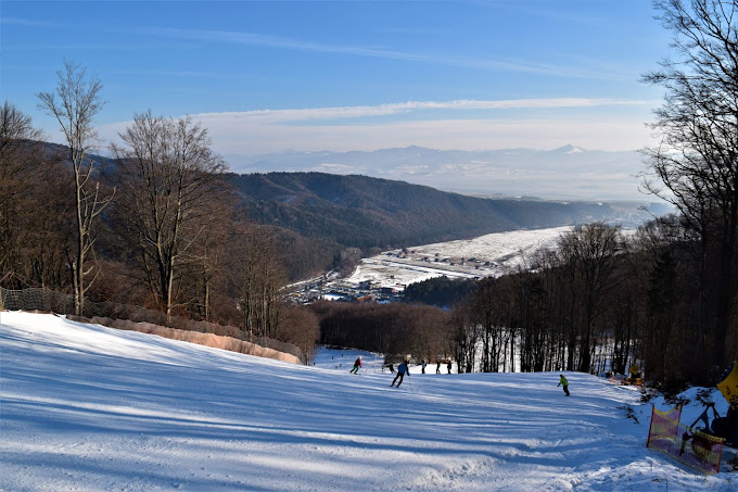 Valčianska Valley in Slovakia - a group of people skiing down a snow covered slope.