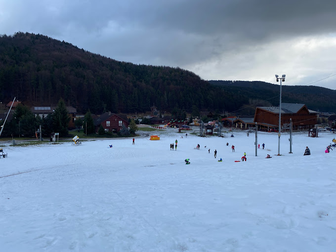 Valčianska Valley in Slovakia - a group of people skiing down a snow covered slope.
