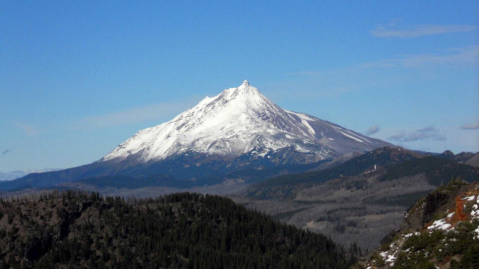 Mt. Jefferson in USA - a mountain with a snow covered peak in the background.