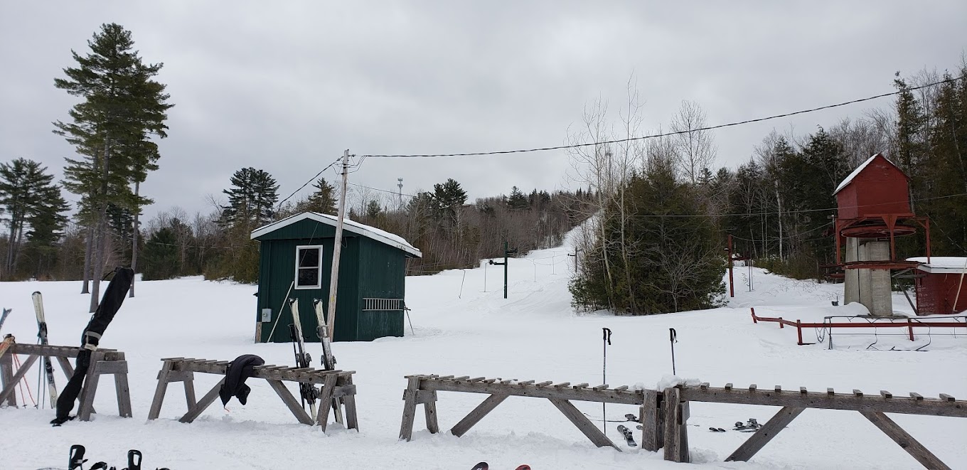 Mt. Jefferson in USA - a small cabin sits in the snow next to a fence.