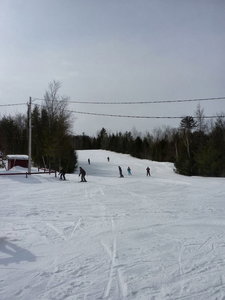 Mt. Jefferson in USA - a group of people skiing down a snow covered slope.