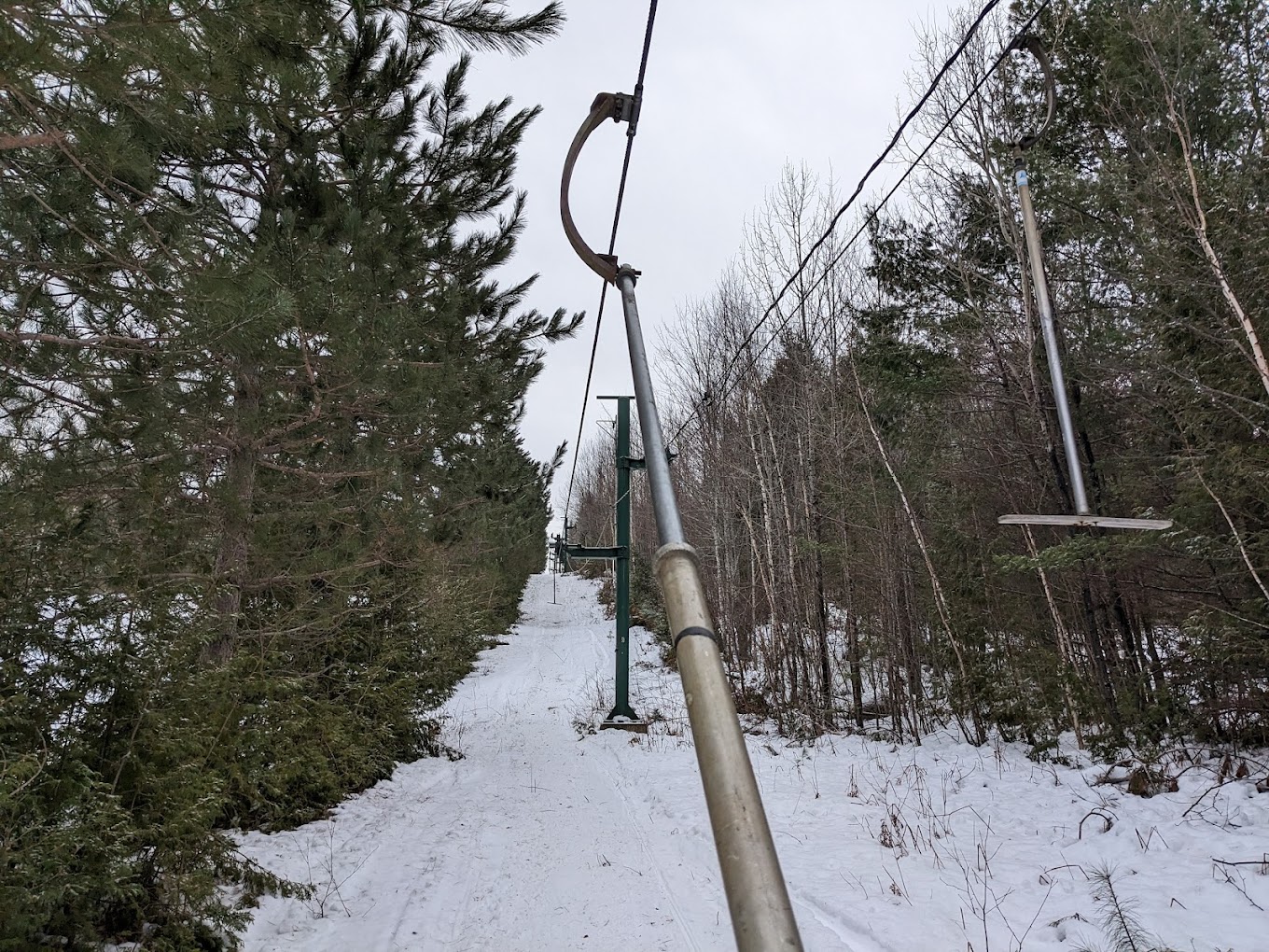 Mt. Jefferson in USA - a metal pole in the middle of a snowy forest.