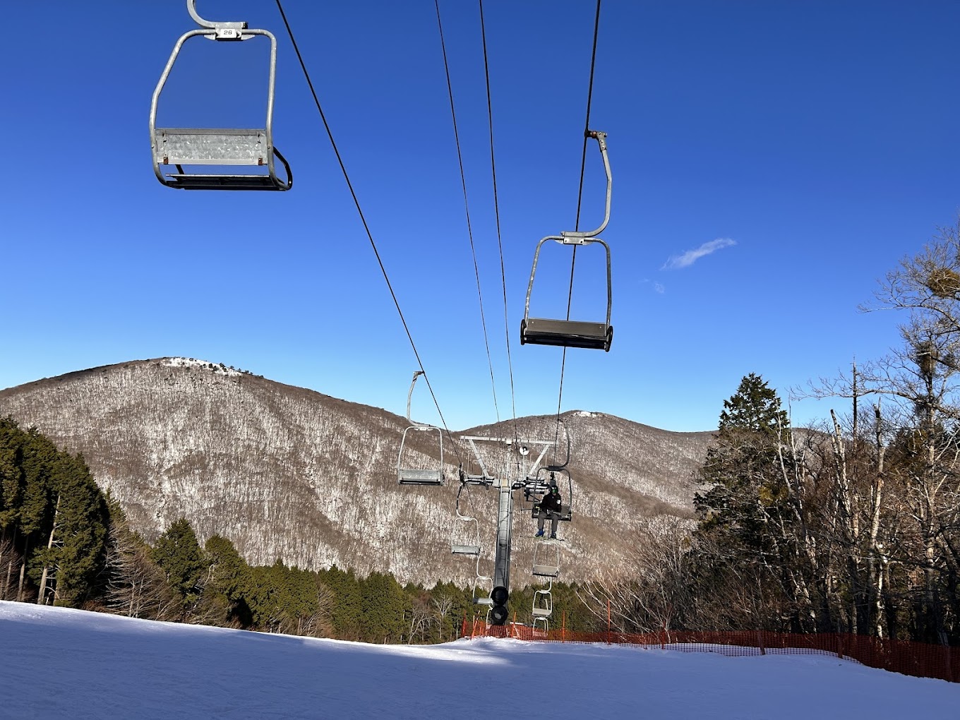 Kenmin-no-mori in Japan - a ski lift going up a snowy slope.