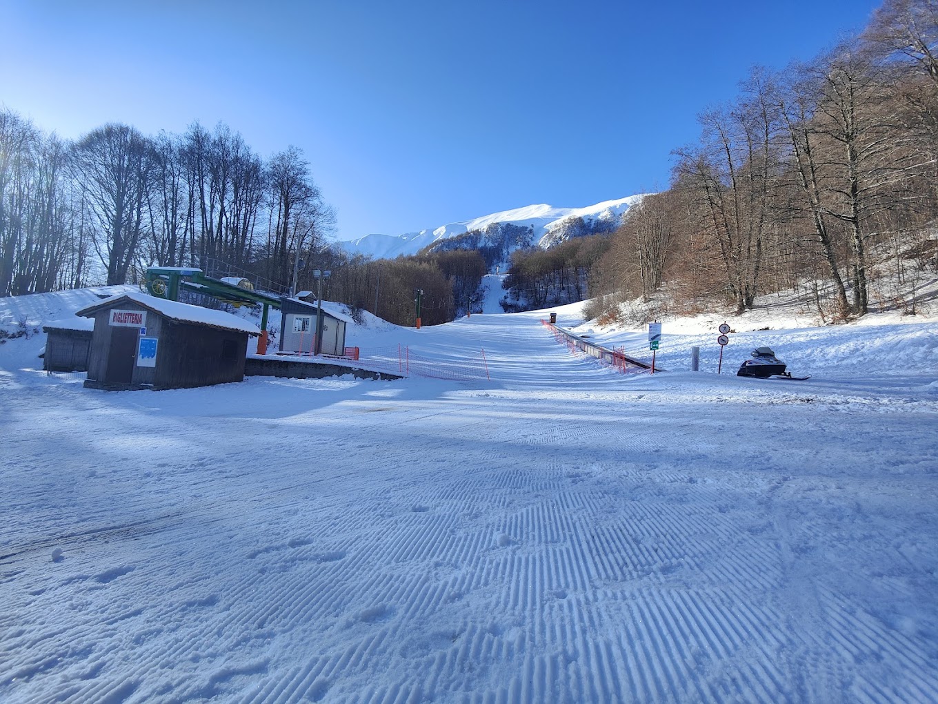 Monte Sirino -Conserva in Italy - a snow covered ski slope with trees in the background.