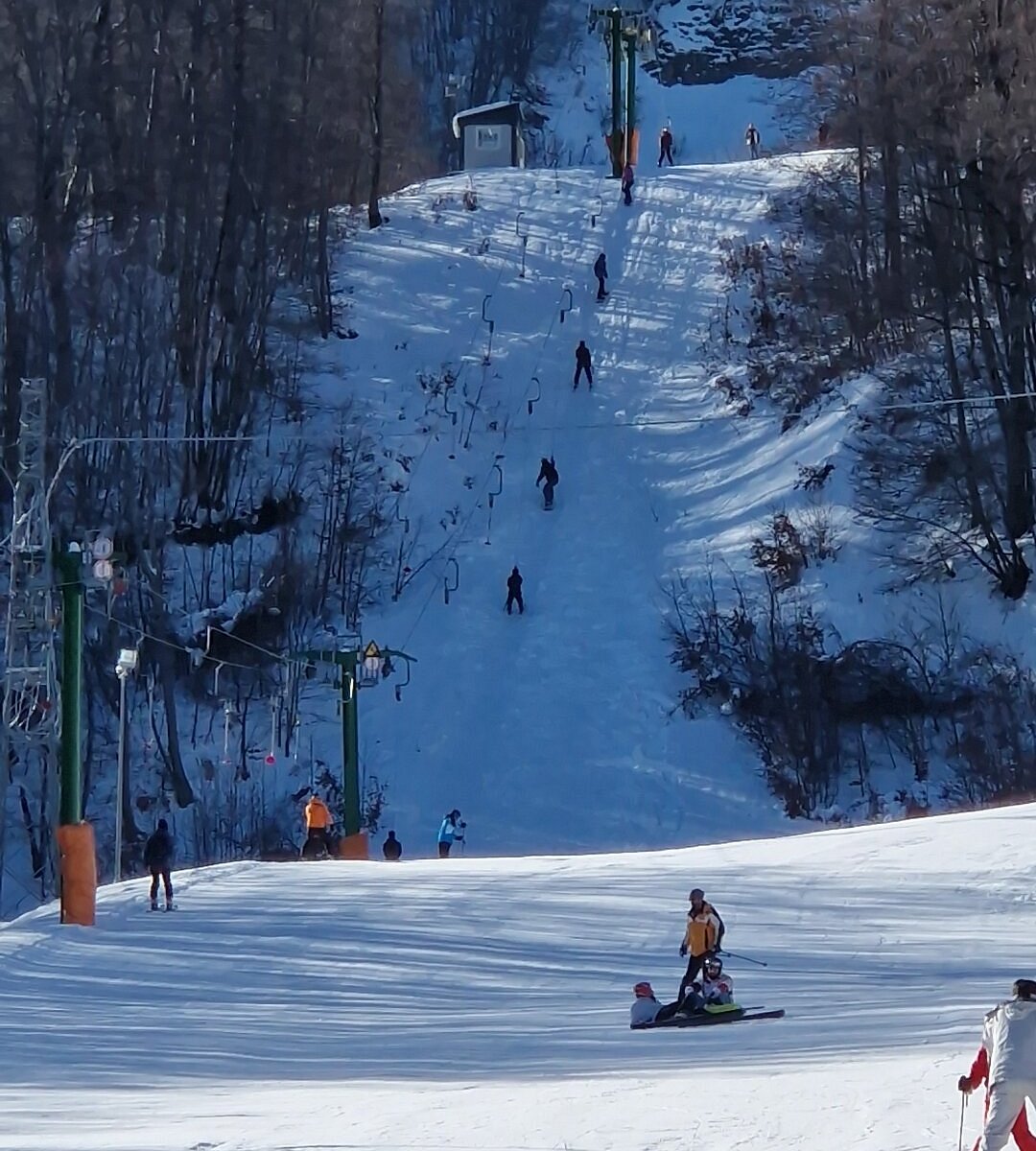 Monte Sirino -Conserva in Italy - a group of people skiing down a snowy hill.