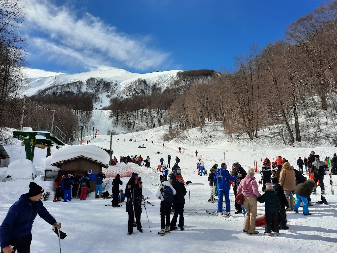 Monte Sirino -Conserva in Italy - a group of people skiing down a snow covered slope.