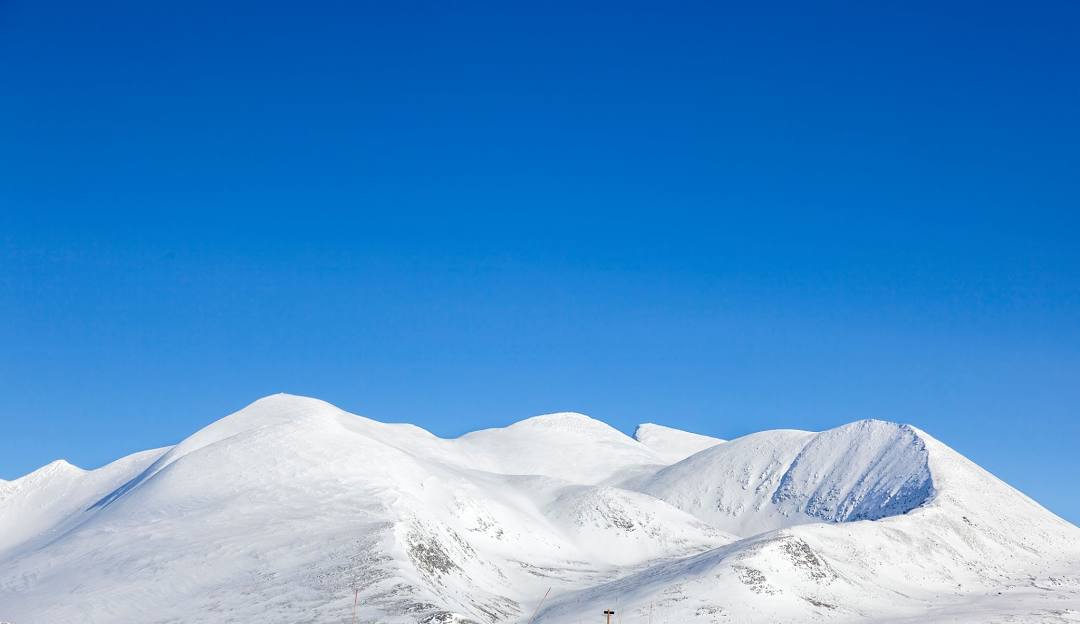 Nordic Mountain in USA - snow covered mountains against a blue sky.