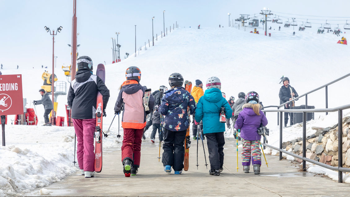Wilmot Mountain in USA - a group of people walking down a snow covered walkway.