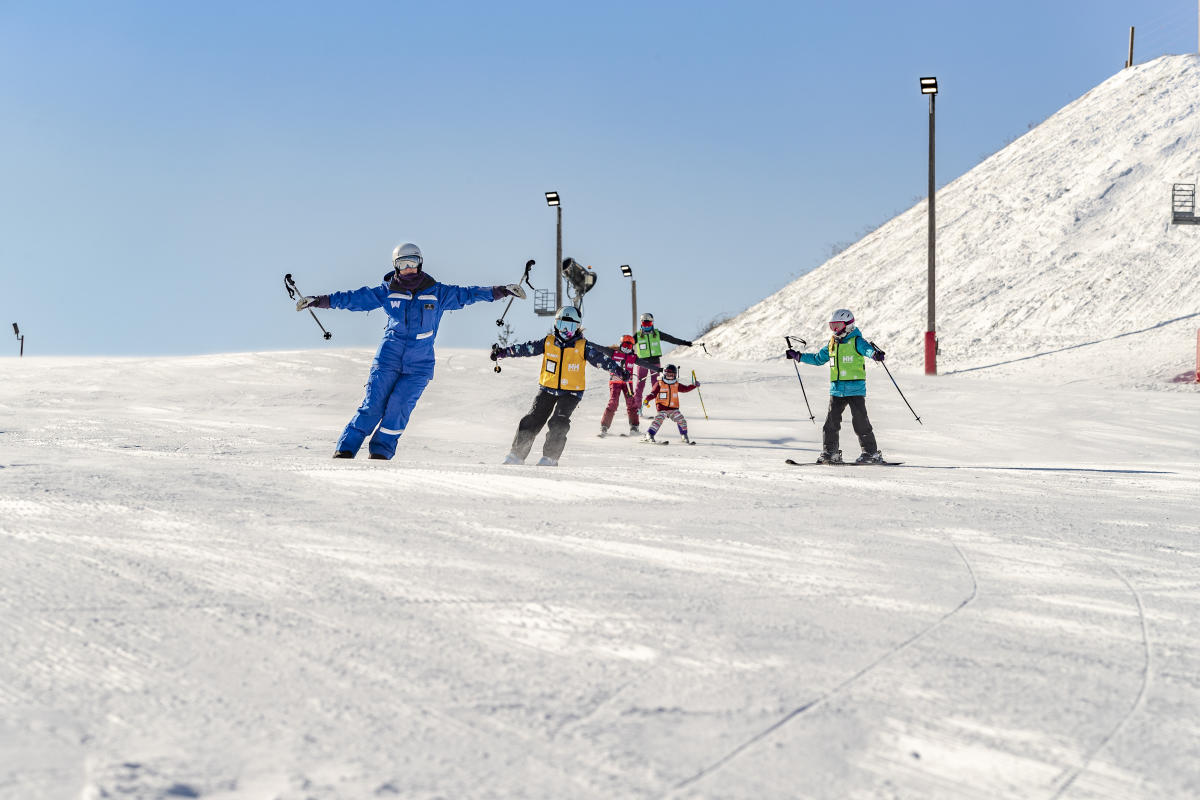 Wilmot Mountain in USA - a group of people skiing down a snowy hill.