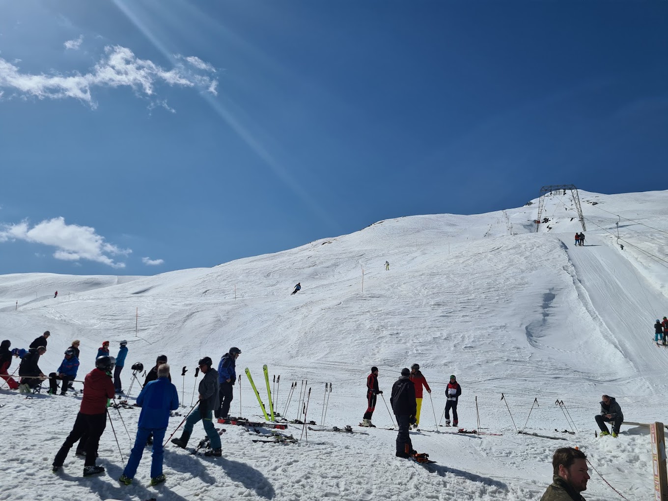 Avers in Switzerland - a group of people skiing down a snowy slope.