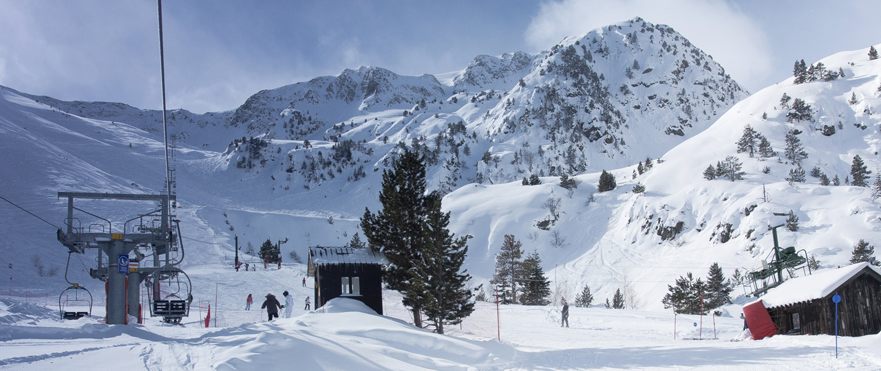 Pleta del Prat – Tavascan in Spain - a group of people skiing down a snowy mountain.