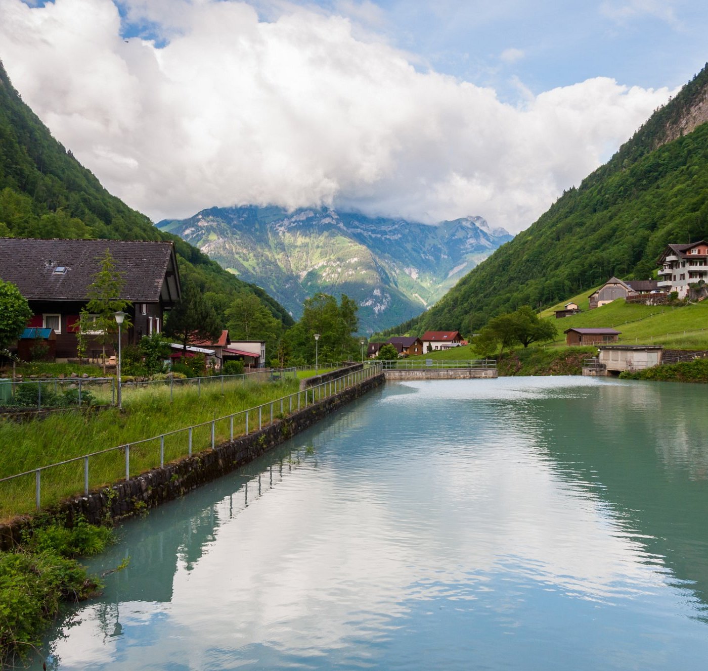 Gitschenen in Switzerland - a body of water with mountains in the background.