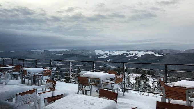 Buscat Ski & Summer Resort in Romania - a view of the mountains from the top of the mountain.