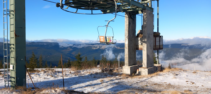 Buscat Ski & Summer Resort in Romania - a ski lift at the top of a mountain.