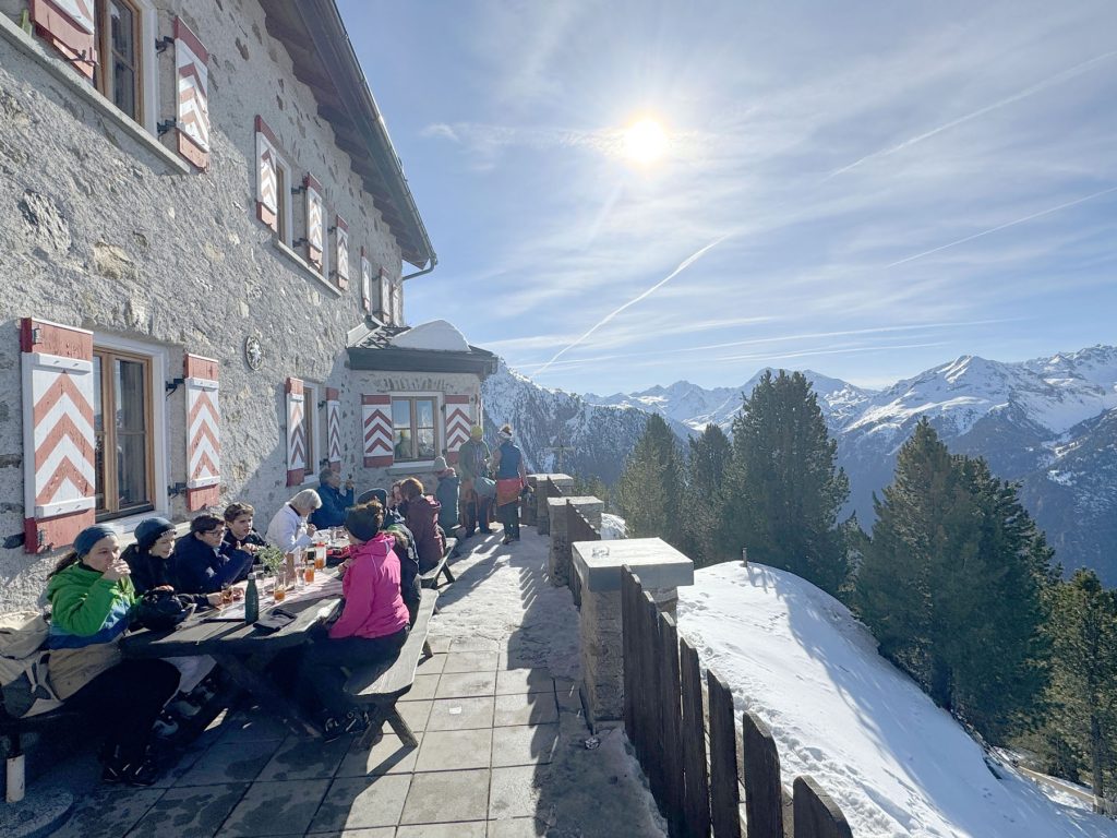 Hochoetz in Austria - a group of people sitting at a table in the snow.