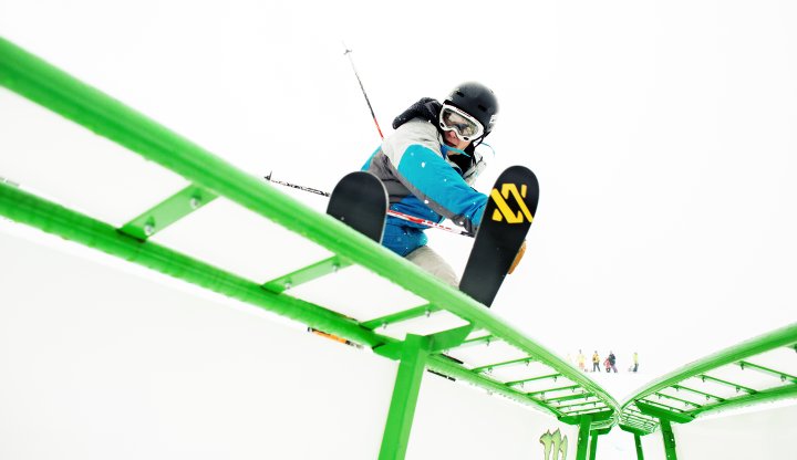 Shanty Creek Summit Mountain in USA - a snowboarder doing a trick in the air.