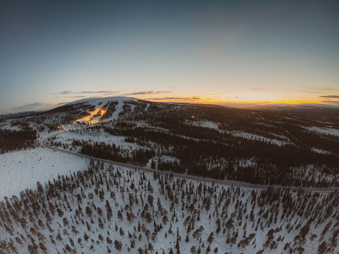Näsfjället in Sweden - an aerial view of a snowy mountain at sunset.