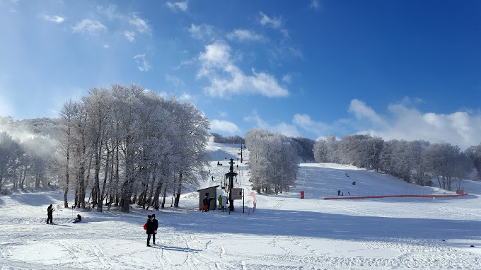 Laguiole in France - a snow covered ski slope with people on it.