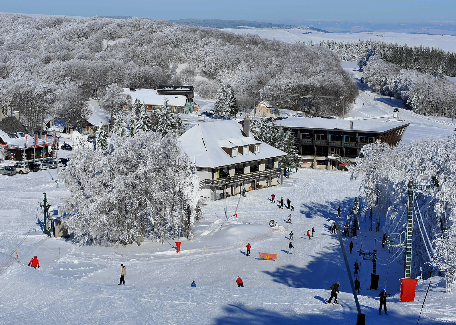 Laguiole in France - a group of people skiing down a snowy hill.