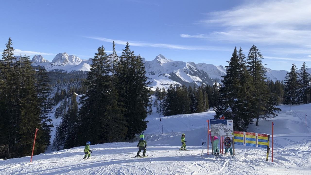 Selital in Switzerland - a group of people skiing down a snow covered slope.