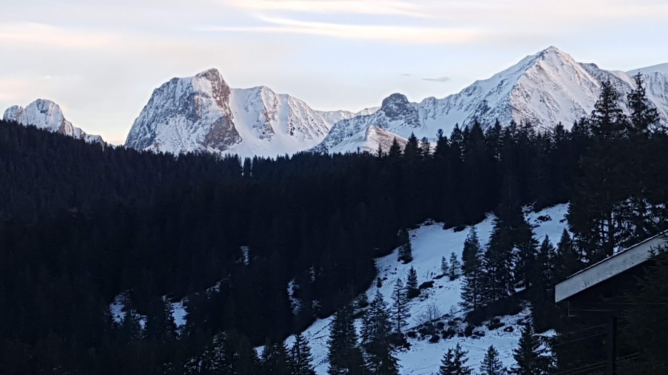 Selital in Switzerland - the mountains are covered in snow as the sun sets.