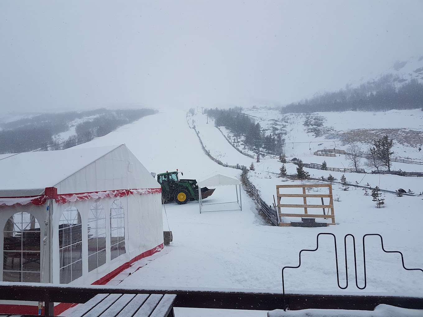 Lemonsjø Alpinsenter in Norway - a snow covered ski slope with a tractor in the snow.