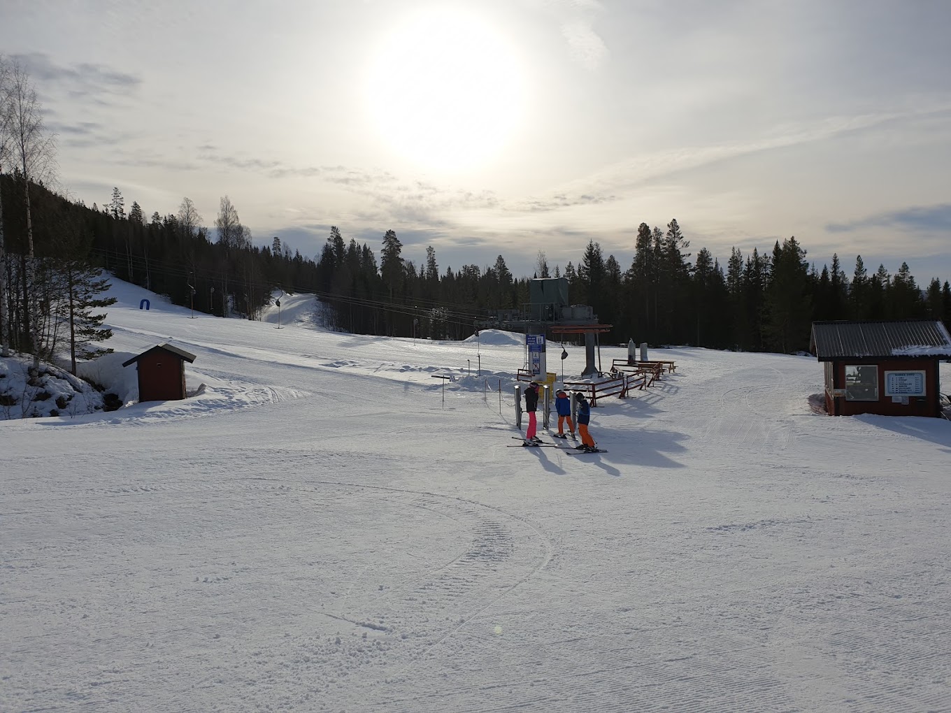 Fulufjellet in Norway - a group of people skiing down a snow covered slope.