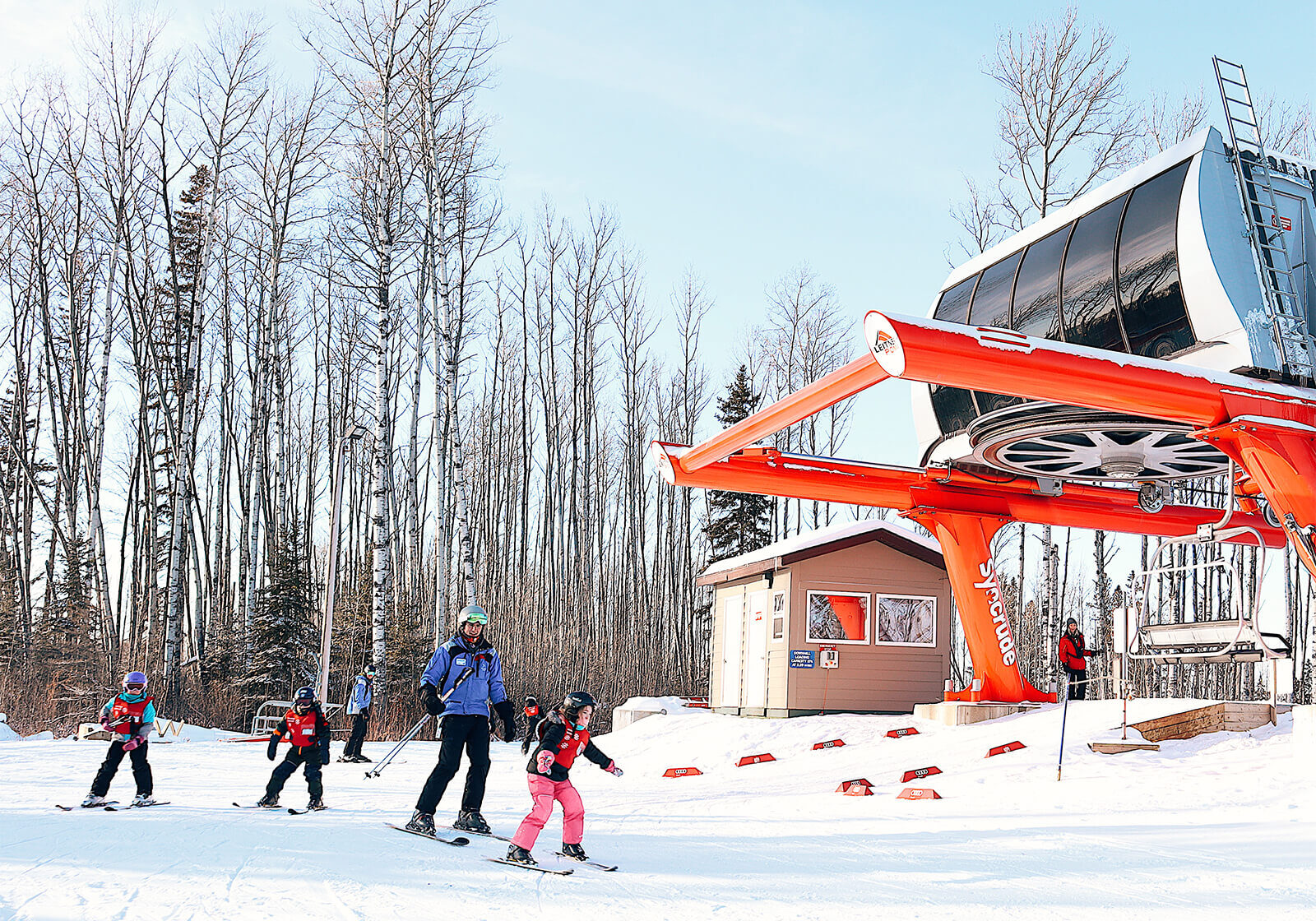 Vista Ridge in Canada - a group of people riding ski boards down a hill.