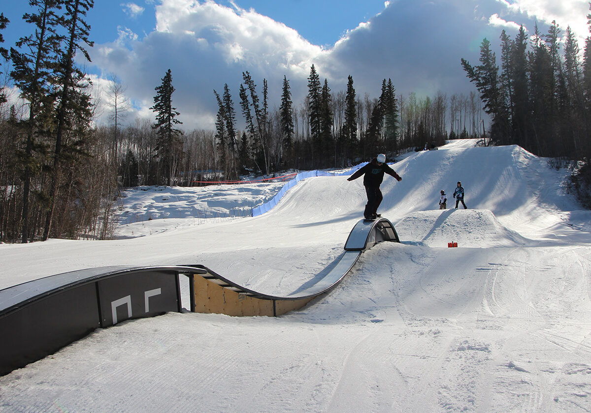 Vista Ridge in Canada - a person on a snowboard going down a ramp.