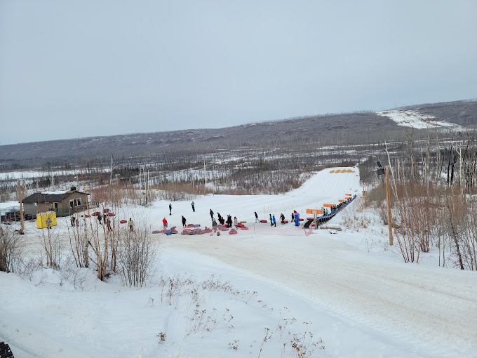 Vista Ridge in Canada - a group of people walking down a snow covered road.