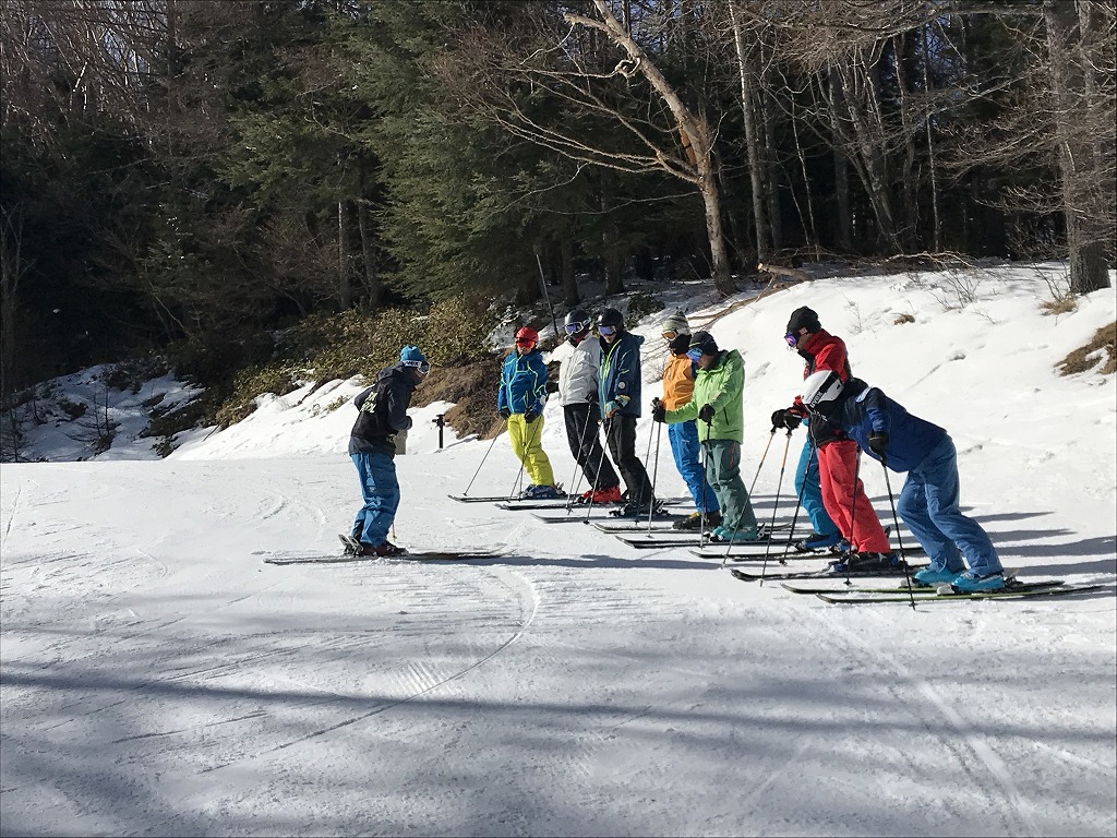 Yachiho Kogen in Japan - a group of people skiing down a hill.