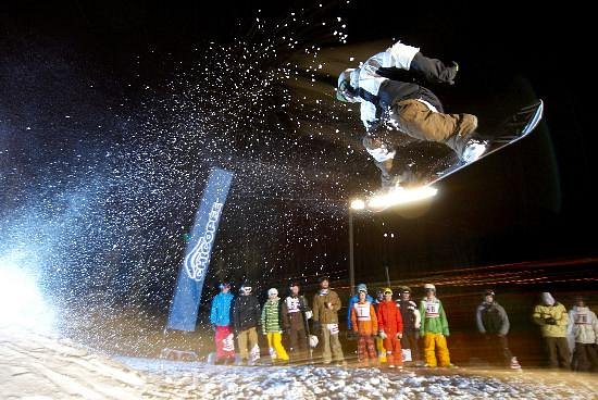 A snowboarder gliding through the snowy slopes in Chicopee, Southern Ontario, Canada, showcasing the exhilaration and beauty of winter sports.