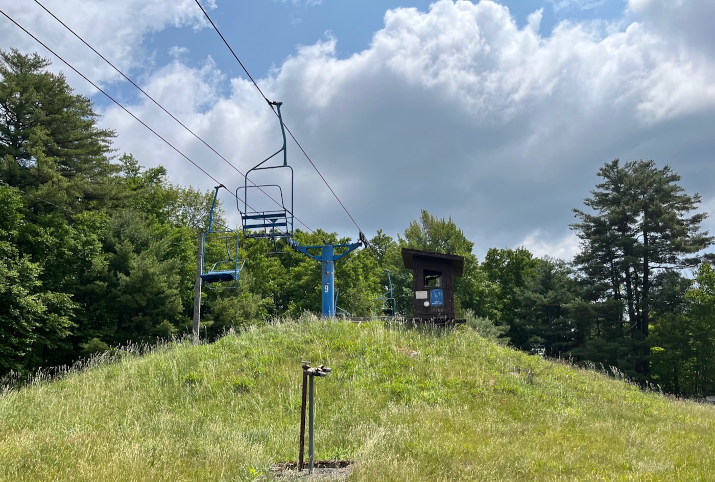 Holiday Mountain -NY in USA - a blue chair sitting on top of a hill.