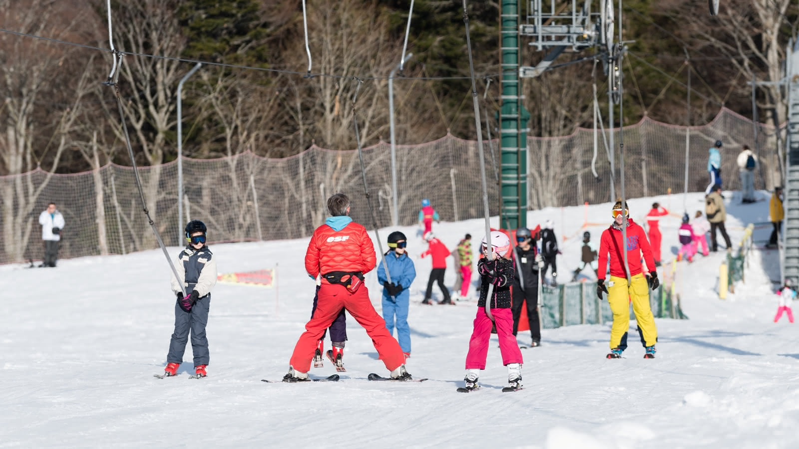 Le Markstein in France - a group of people skiing down a snowy hill.