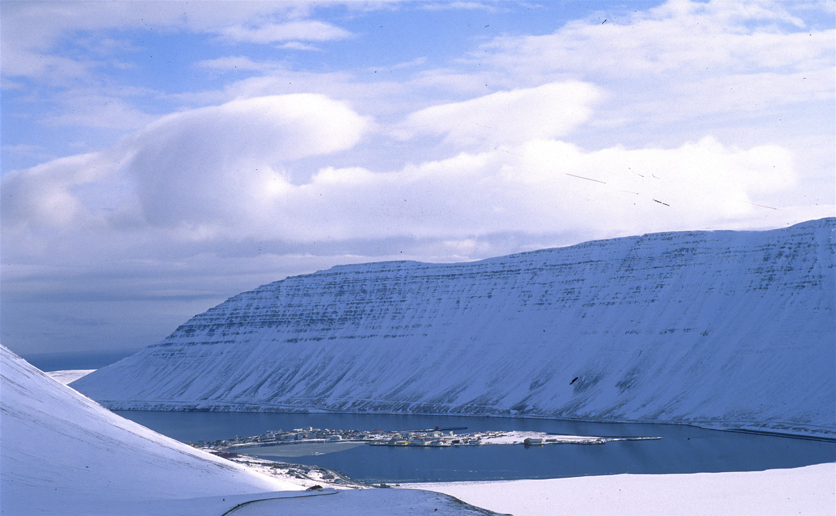Isafjördur in Iceland - a view of a mountain with a lake in the middle.