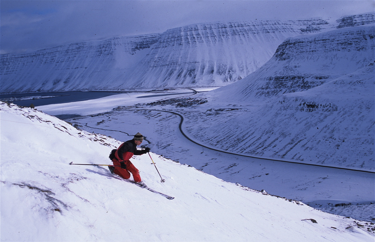 Isafjördur in Iceland - a person skiing down a snowy mountain.