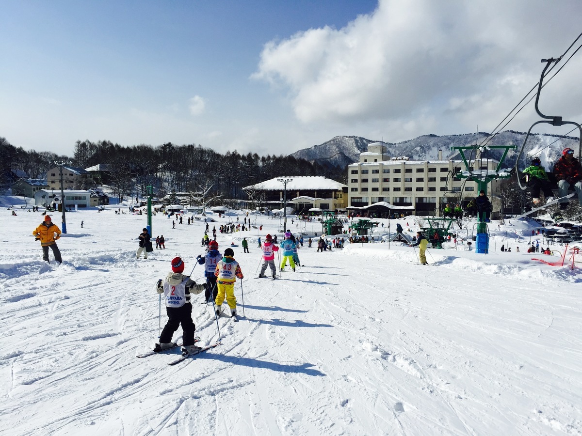 Minakami Kogen Fujiwara in Japan - a group of people skiing down a snowy slope.