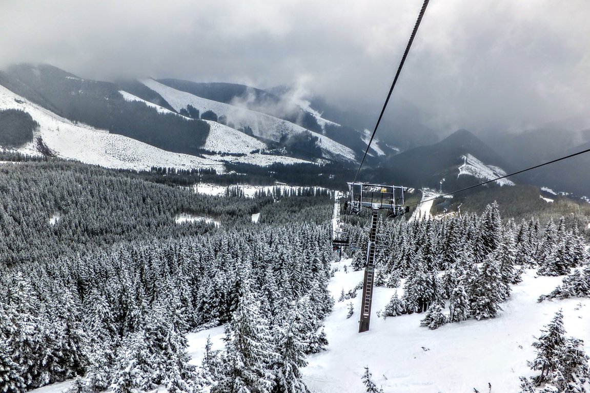 Jasná Nízke Tatry – Chopok in Slovakia - a ski lift going up a snowy mountain.