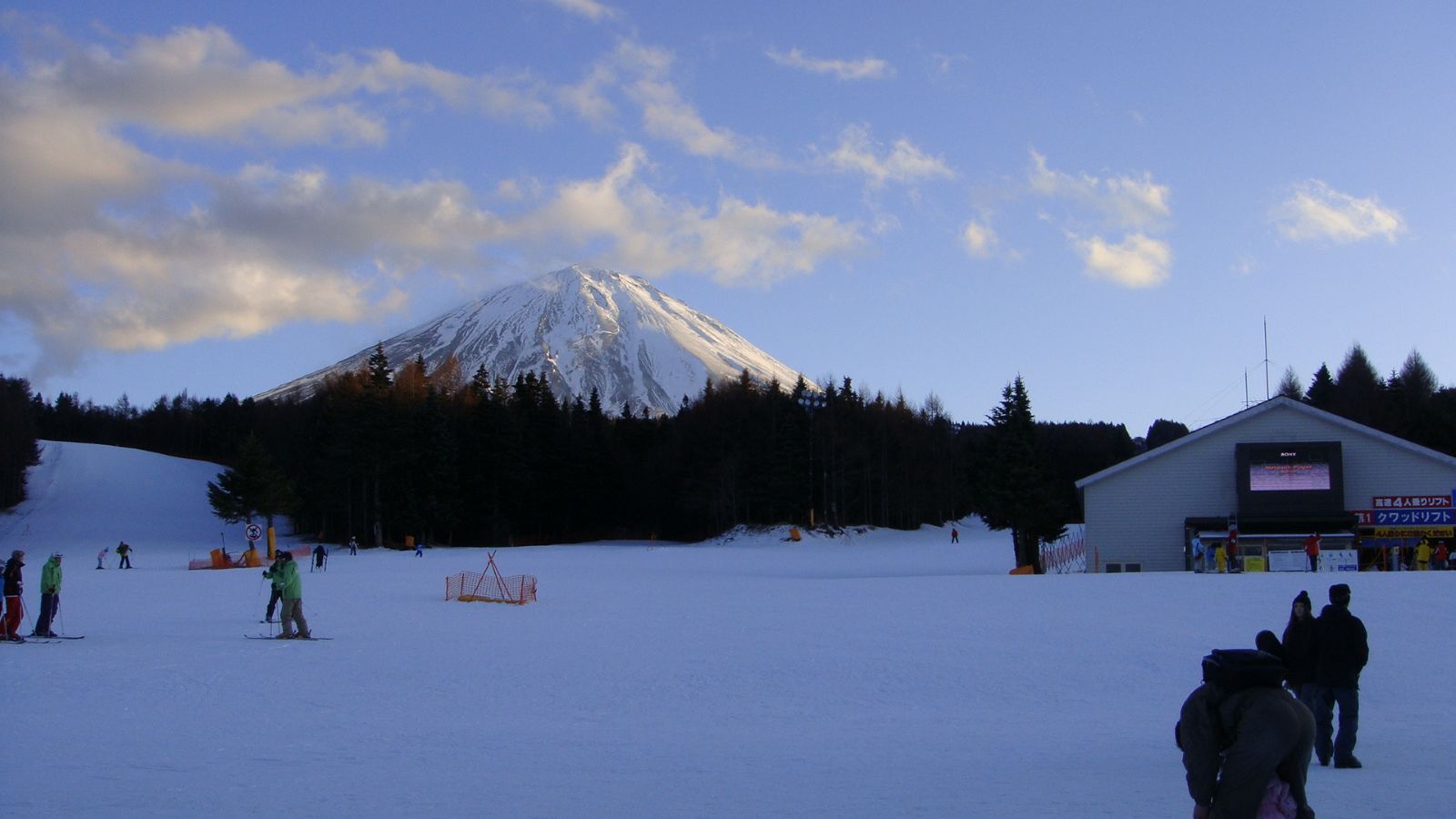 Kamui Misaka in Japan - a group of people standing on a snow covered ski slope.